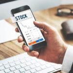 Beginner investor using a stock market app with a SIP calculator to estimate investment returns and financial goals