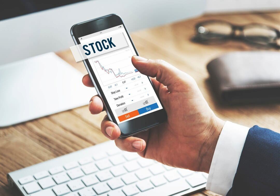 Beginner investor using a stock market app with a SIP calculator to estimate investment returns and financial goals